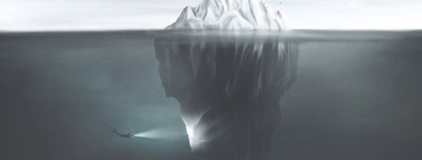 an iceberg with a diver illuminating hidden areas of ice representing tax opportunities